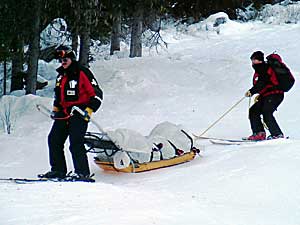 Mike Henness being take down in a sled by ski patrol at Sun Peaks, Canada, Dec. 2005.